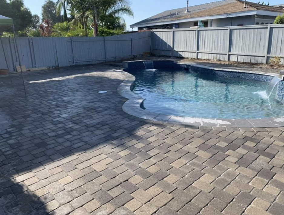New paver pool deck around a finished swimming pool